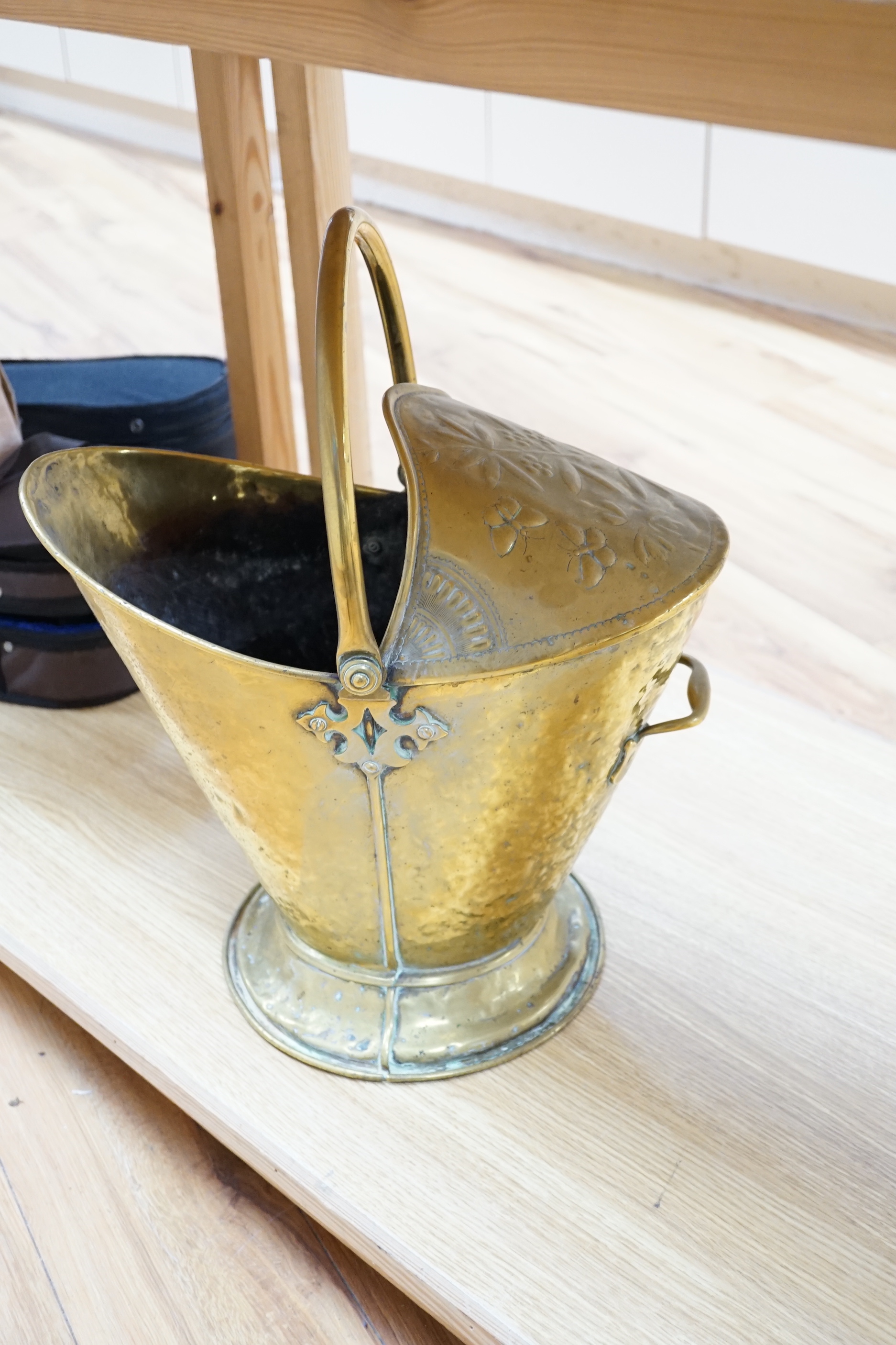 A brass helmet coal scuttle and another